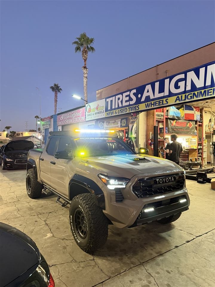 Lifted Toyota Tacoma in front of the shop
