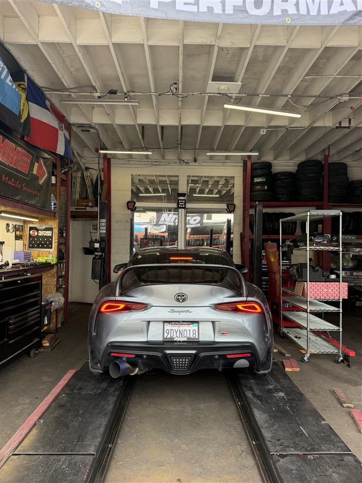 Silver Toyota Supra on the alignment rack